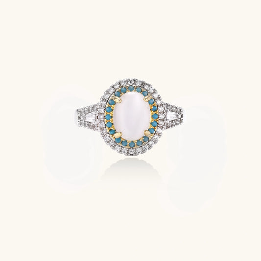 Vintage-style cocktail ring with luminous cat's eye center stone surrounded by turquoise and crystal double halo on white gold plated band