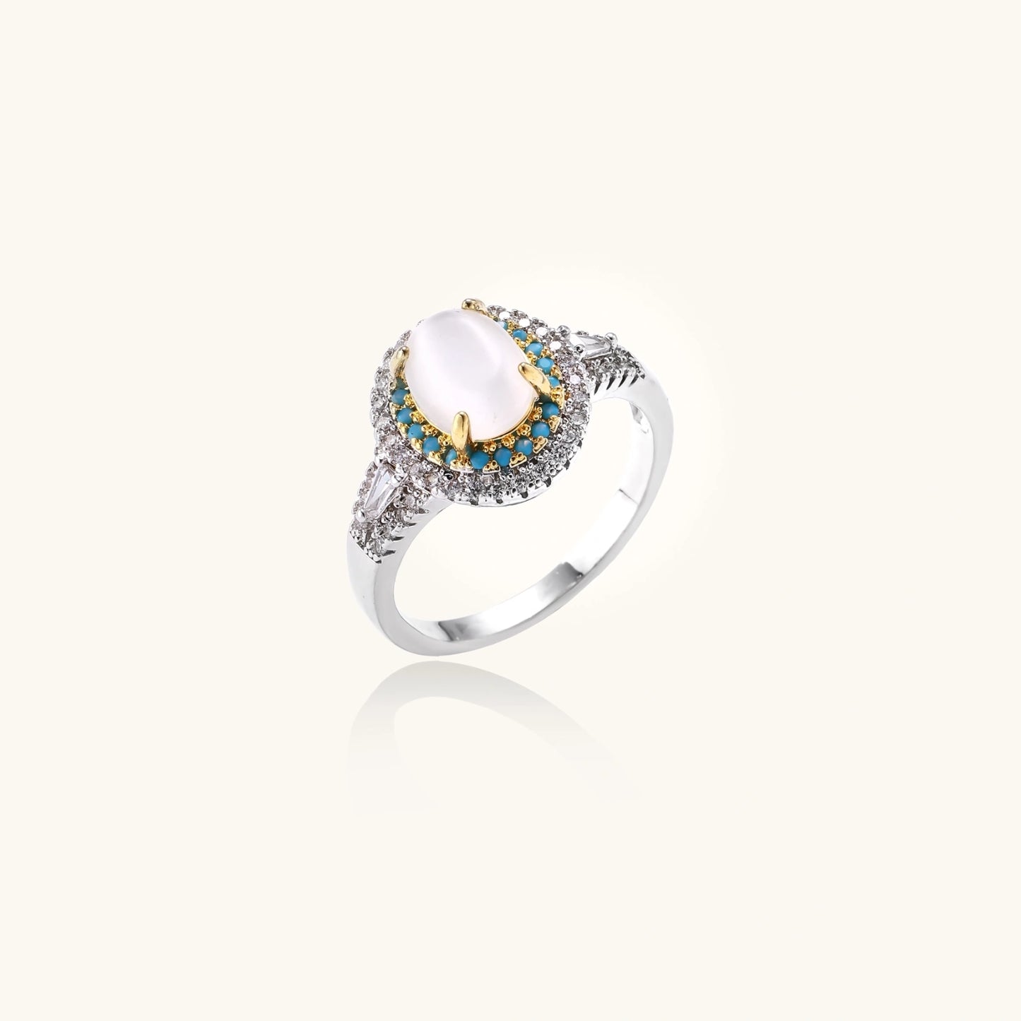 Vintage-style cocktail ring with luminous cat's eye center stone surrounded by turquoise and crystal double halo on white gold plated band