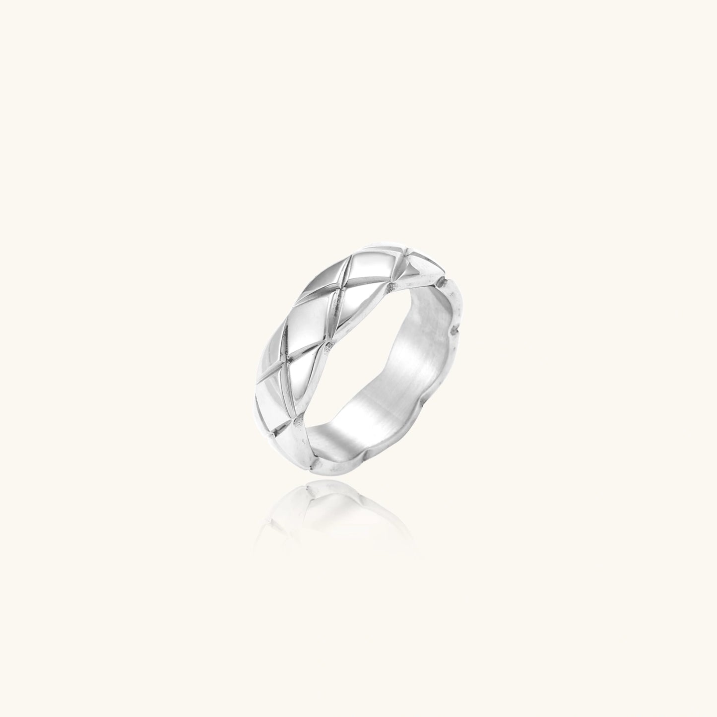 Braided stainless steel band ring with geometric interwoven strands in brushed silver finish on white background